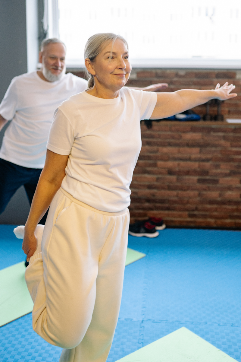 Two older people exercising.